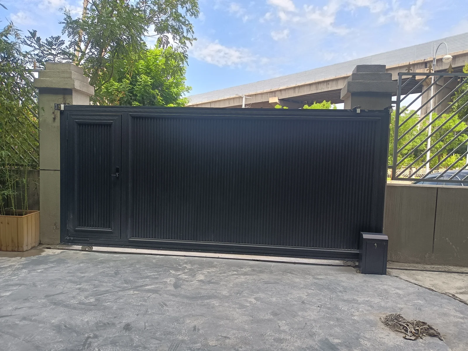 A screened gate along a landscaped driveway — Stuttgart, Germany.