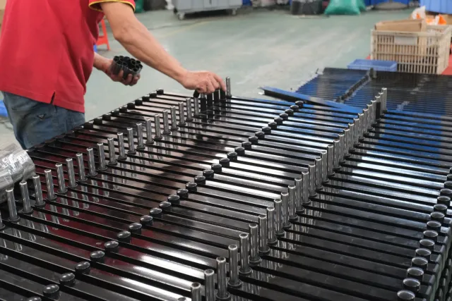 A Hengbo worker assembling gate connecting components and metal shafts