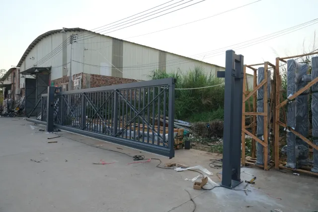 A large dark gate structure outside the Hengbo workshop building