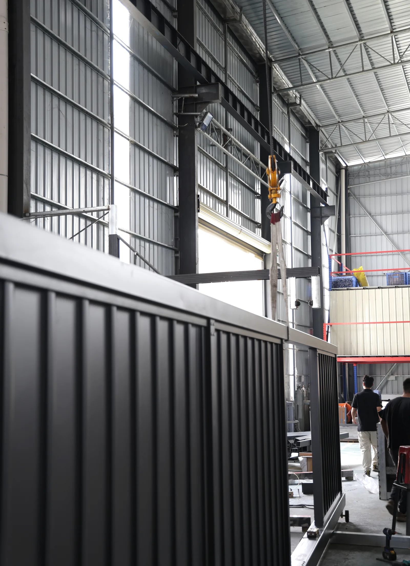 An assembled dark gate panel beneath the workshop roof