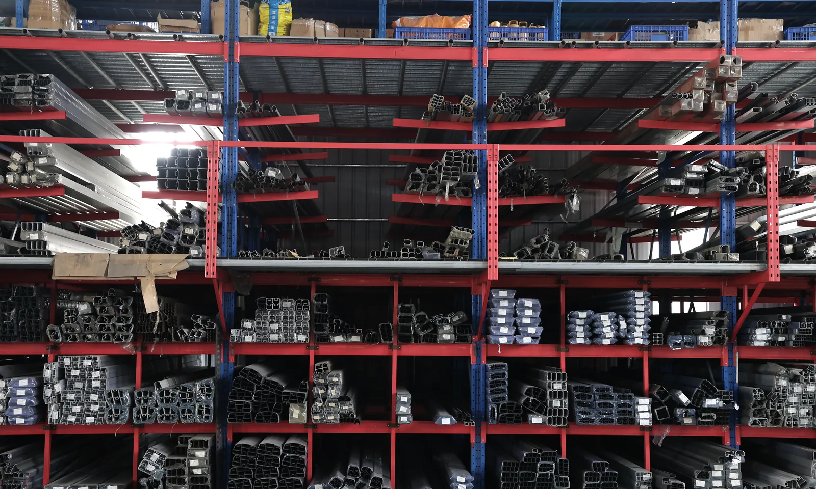 Rows of metal profiles stored by section in the workshop racks
