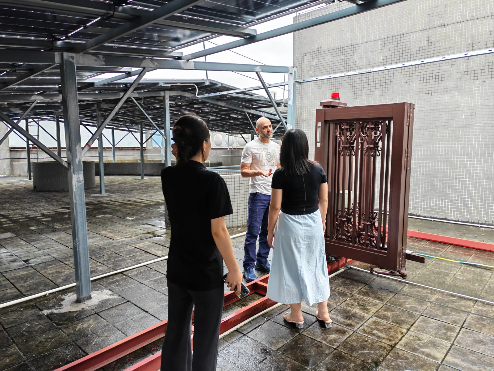 Visitors looking at an entrance gate in the Hengbo workshop