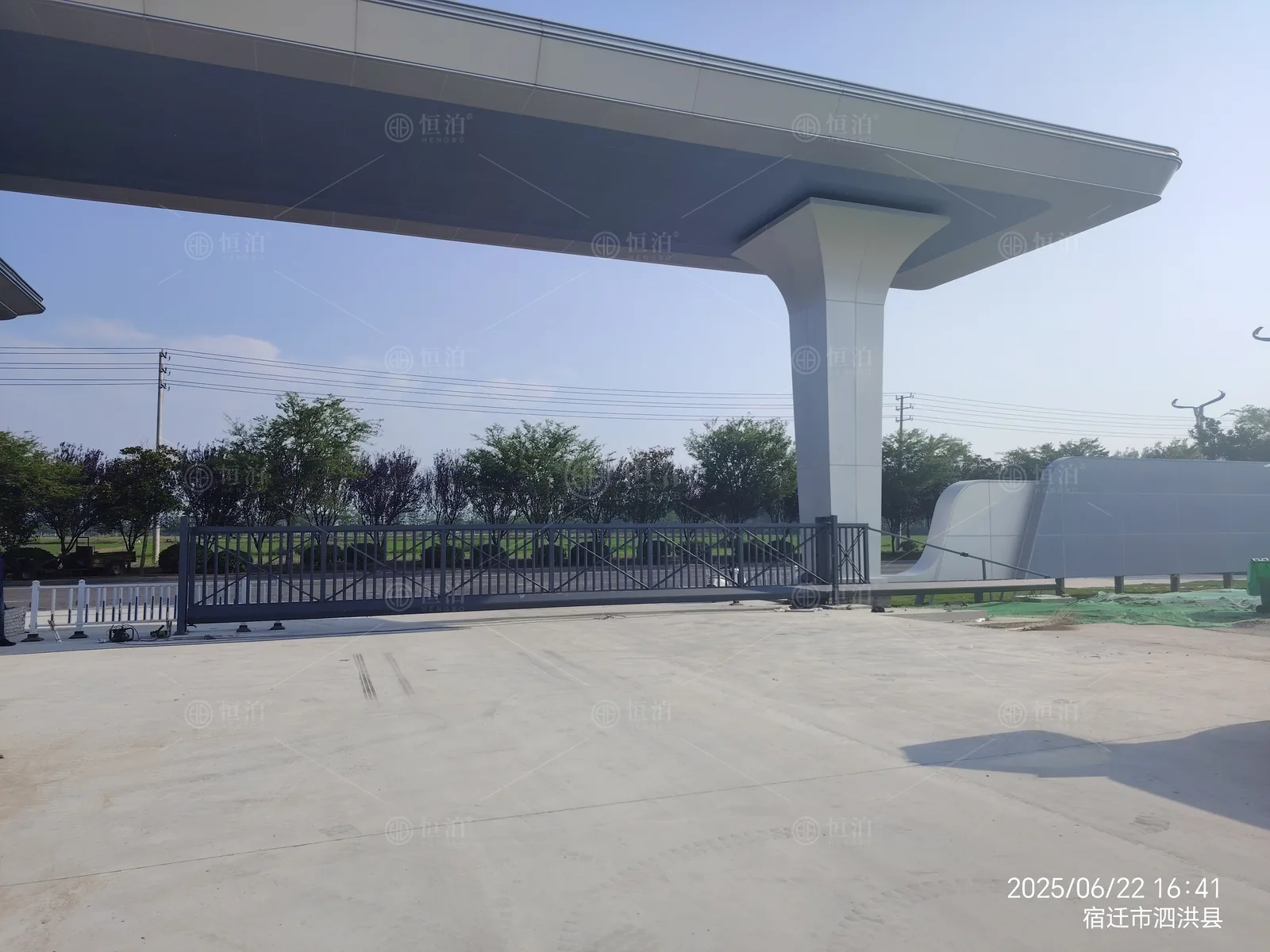 A long cantilever gate beneath an entrance canopy — Singapore, Singapore.