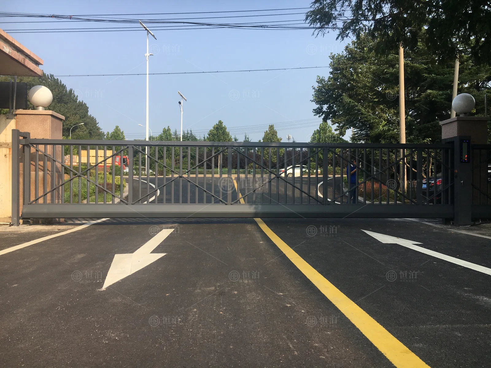 A cantilever gate across a marked factory approach — Rayong, Thailand.