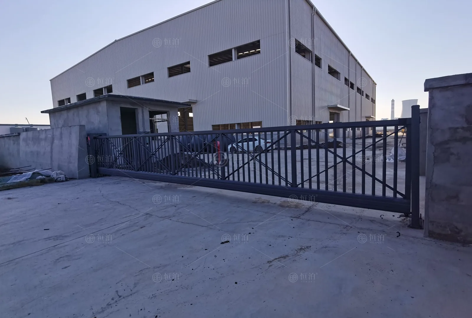An open-bar cantilever gate in a factory yard — Haiphong, Vietnam.